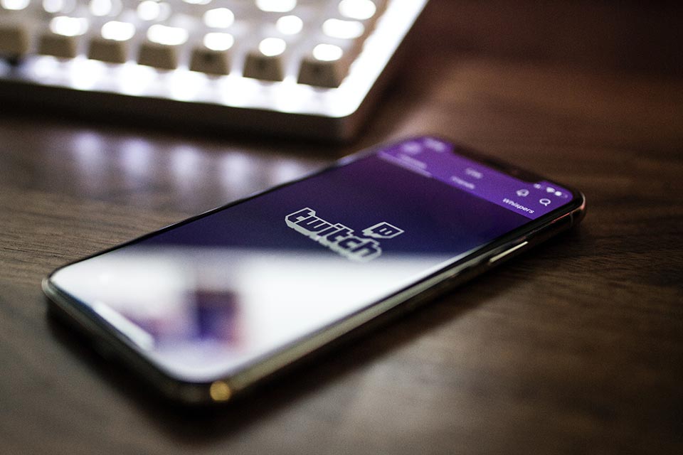 Twitch logo on a smartphone screen on a desk